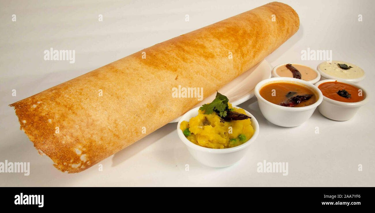 Paper Masala dosa is a South Indian meal served with sambhar and coconut chutney Selective focus - Image Stock Photo