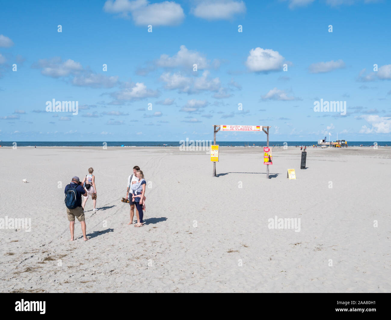 People taking photo on North Sea beach of West Frisian island Schiermonnikoog, Netherlands Stock Photo