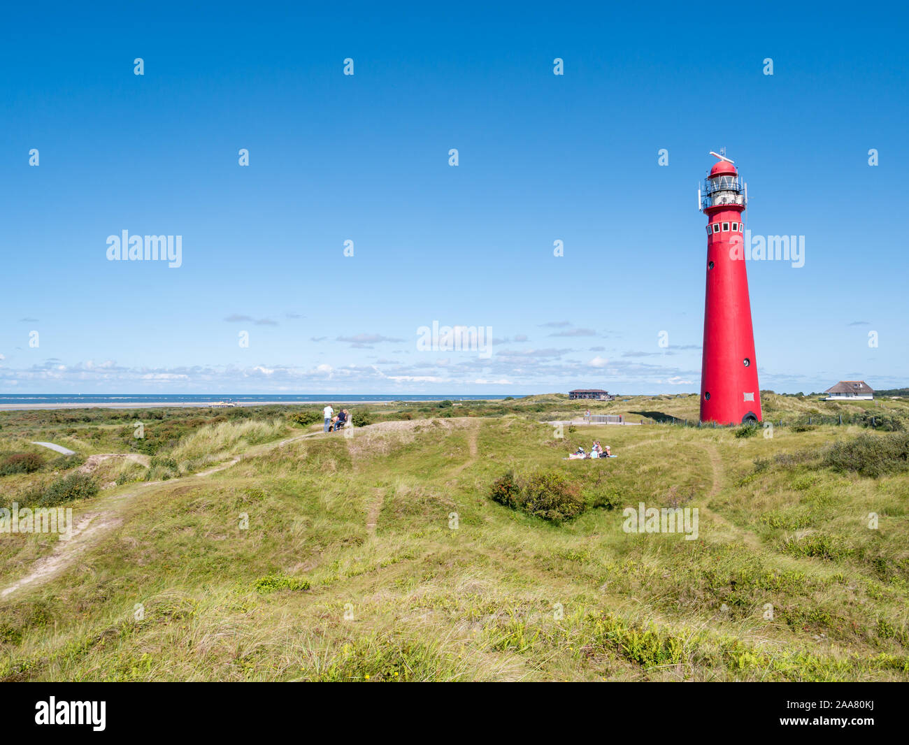 People relaxing near lighthouse in dunes on West Frisian island Schiermonnikoog, Netherlands Stock Photo