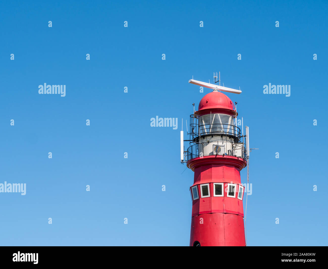 Top of red North Tower lighthouse against blue sky, West Frisian island Schiermonnikoog, Netherlands Stock Photo