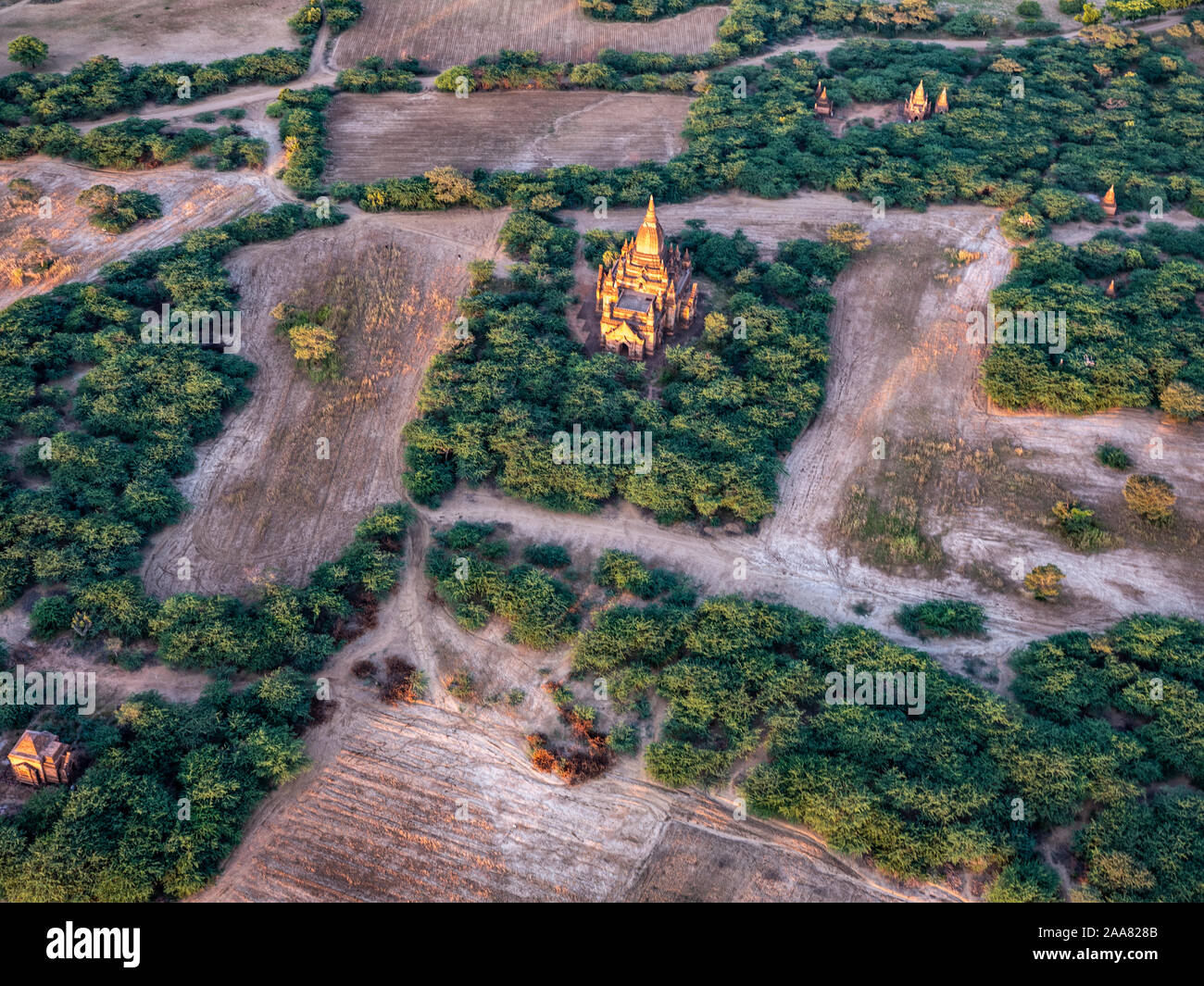 Aerial view of the ancient temples of the archeological zone of Bagan, Myanmar (Burma) as seen from a hot air balloon flying overhead at dawn Stock Photo