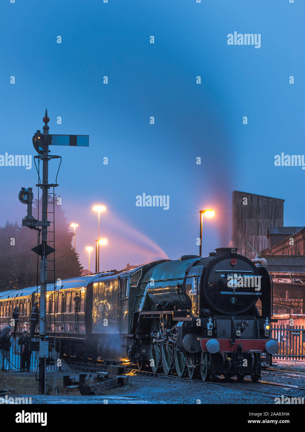 Night shot of the A1 steam locomotive 60163 Tornado awaiting departure in the dark at Severn Valley Railway's Kidderminster station. Stock Photo