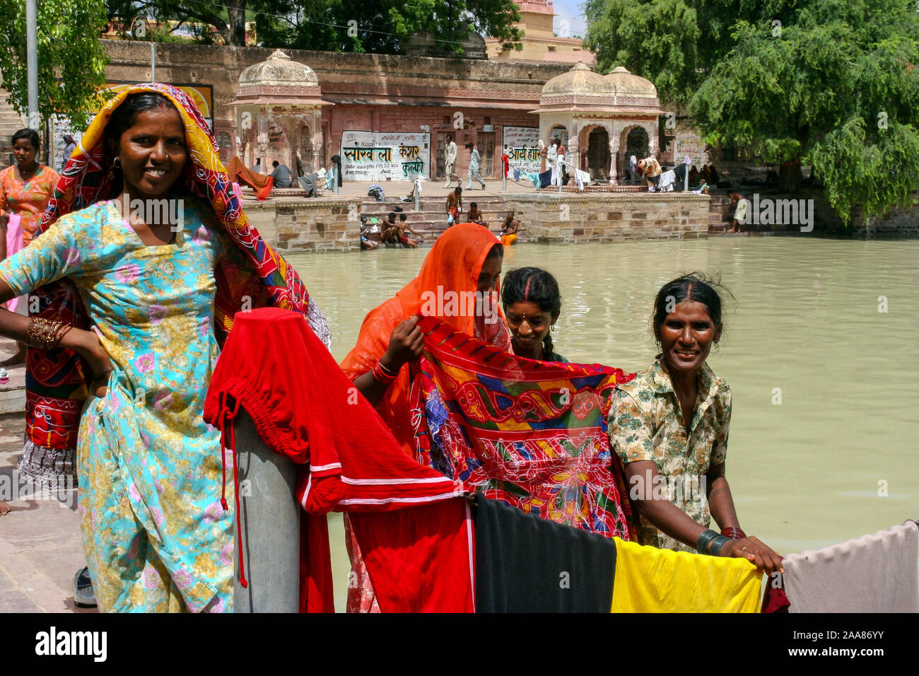 Kolayat, Bikaner, Rajasthan, India: four Indian women in holydays smile along the shores of the sacred lake of Kolayat Stock Photo
