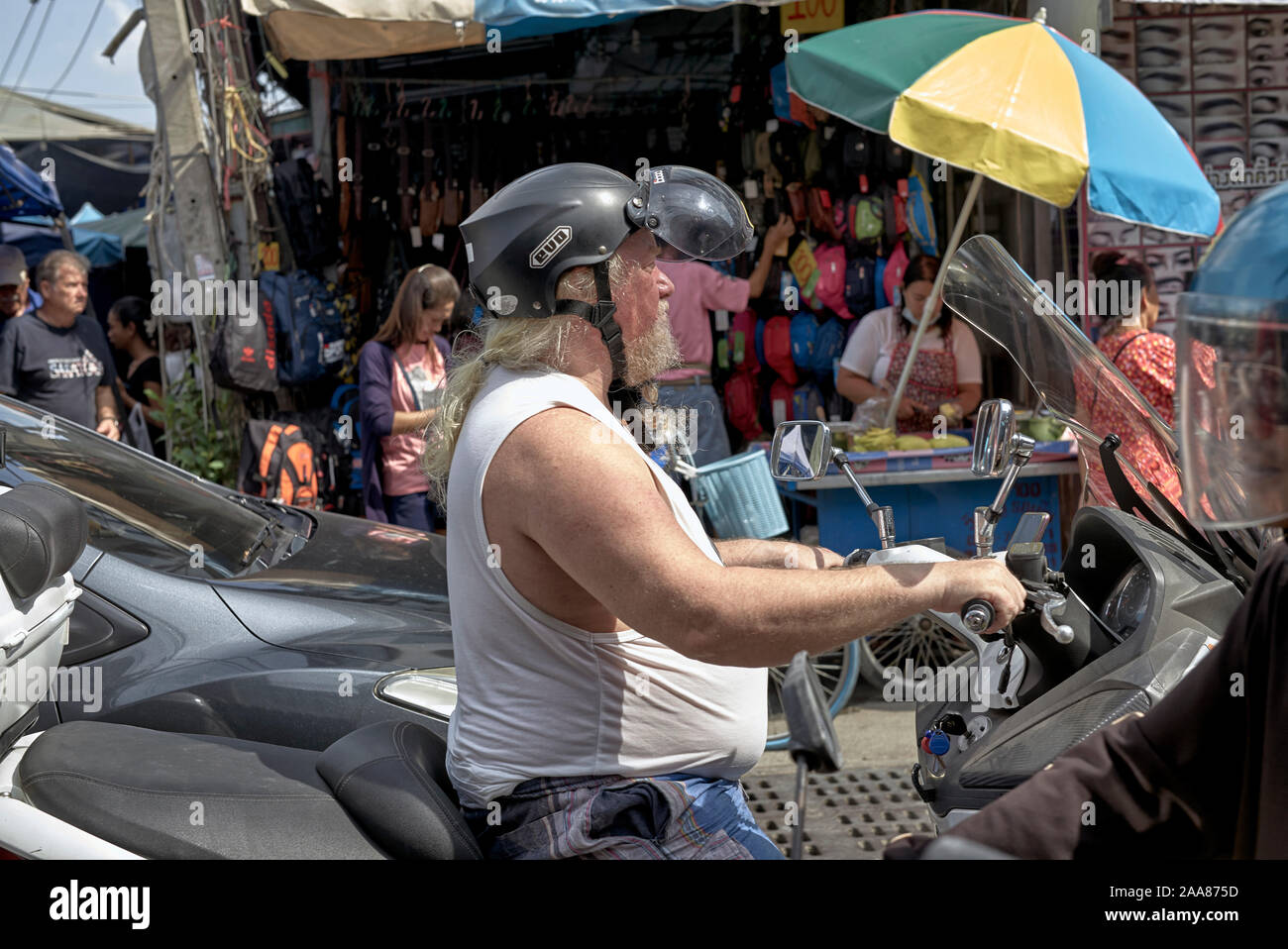 Biker dressed in a singlet and wearing a safety helmet Stock Photo