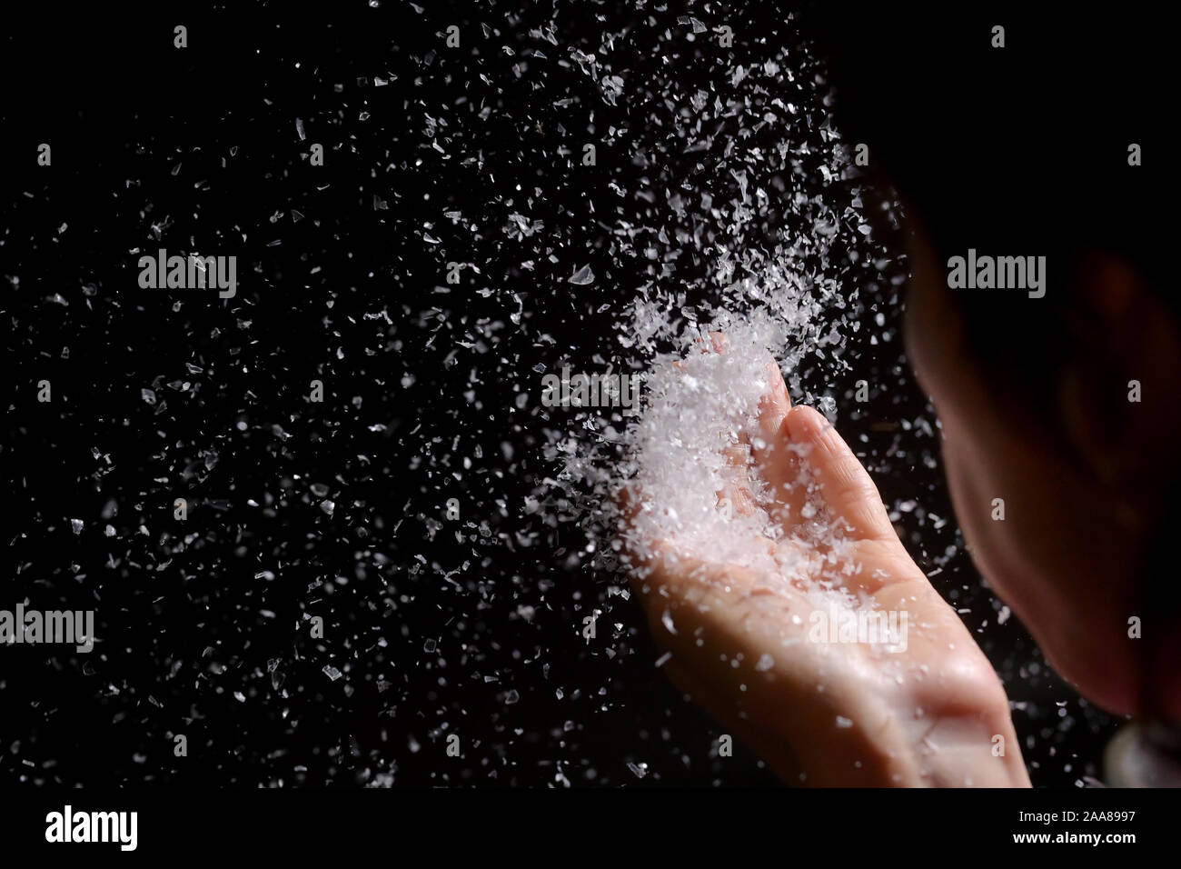 Woman Blowing Fake Snow in The Dark Stock Photo