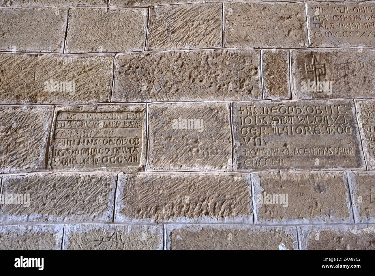 inscriptions of the tombstones between the mozarabic door and gothic chapel of San Victorian, Old Monastery of San Juan de la Pena, Huesca province, A Stock Photo