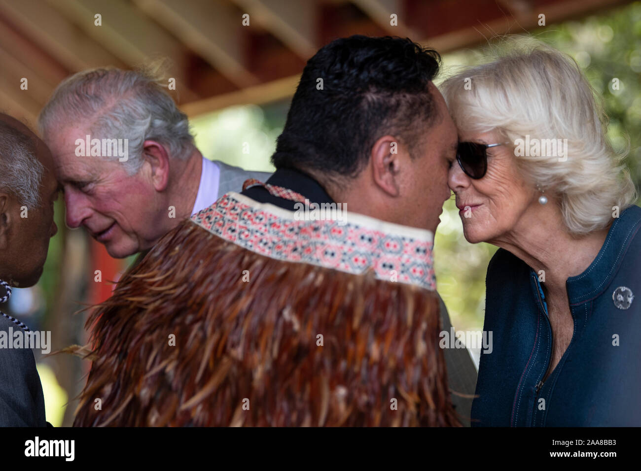 The Prince of Wales and the Duchess of Cornwall receive a traditional hongi gesture during their visit to Waitangi Treaty Grounds, the Bay of Islands, on the fourth day of the royal visit to New Zealand. Stock Photo