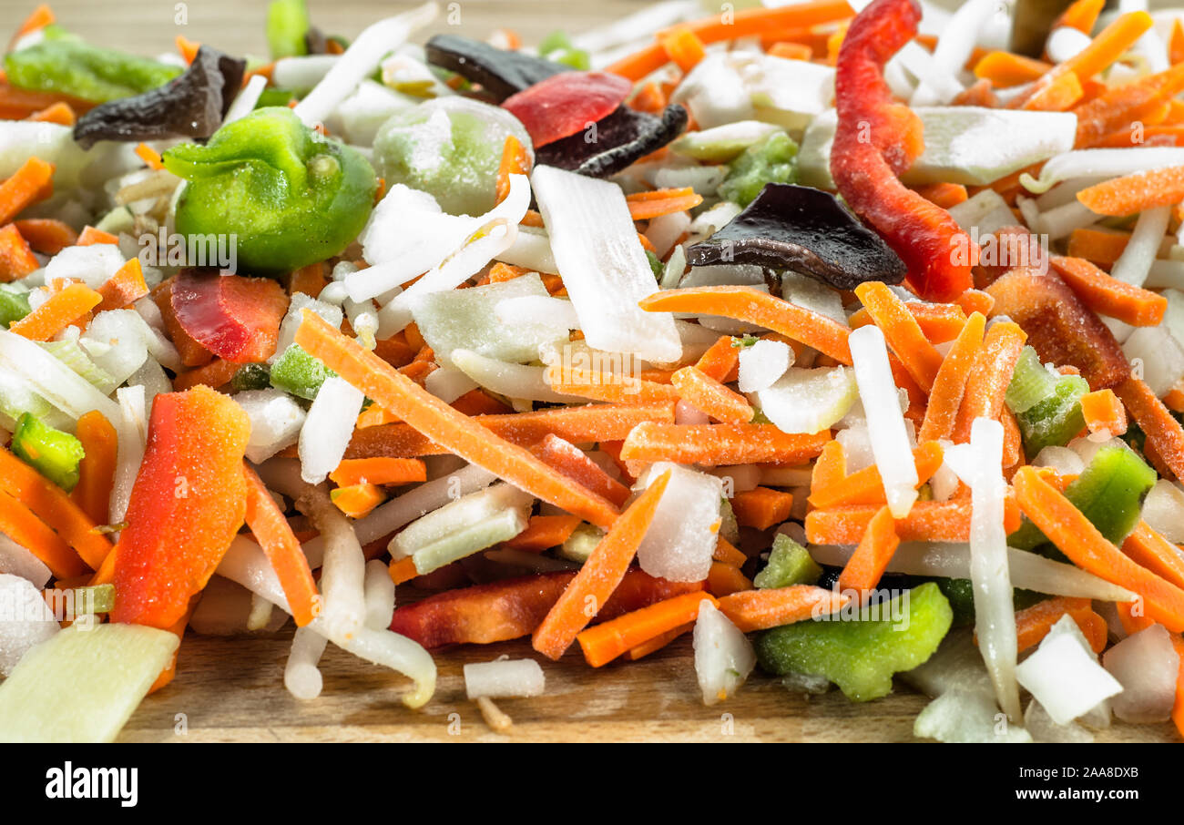 Chinese vegetables sliced in strips on wooden board, selective focus