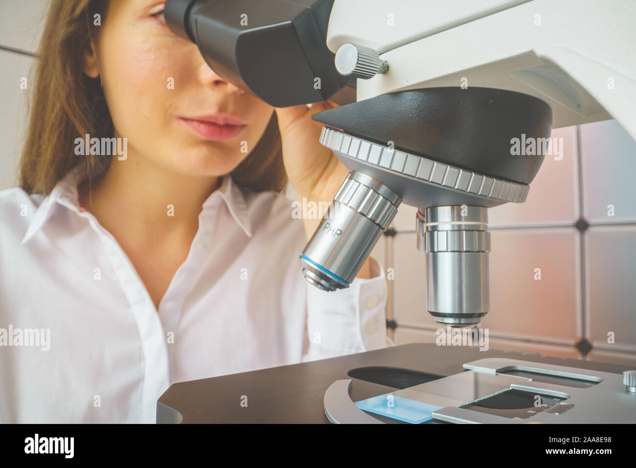 student girl looking in a microscope, science laboratory concept Stock ...