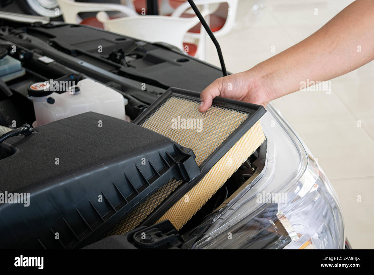 Hand a man change and check air filter of car in the engine room Stock