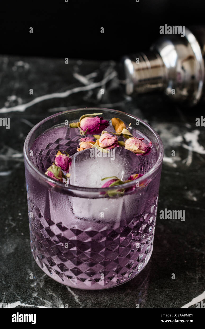 Pink Gin Tonic Cocktail with Dried Rose Buds and Ice in Glass Cup. Ready to  Drink Stock Photo - Alamy