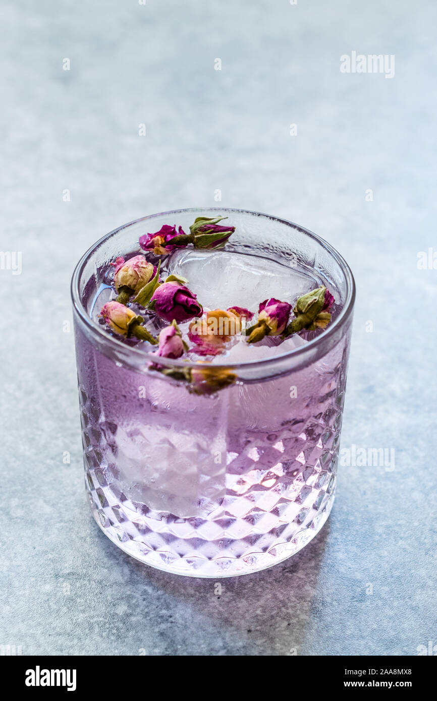 https://c8.alamy.com/comp/2AA8MX8/pink-gin-tonic-cocktail-with-dried-rose-buds-and-ice-in-glass-cup-ready-to-drink-2AA8MX8.jpg