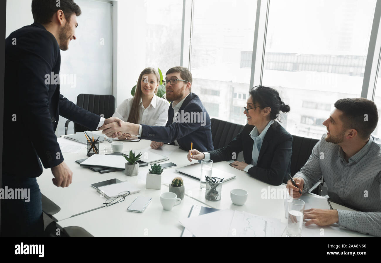 Satisfied HR managers shaking hands with applicant Stock Photo