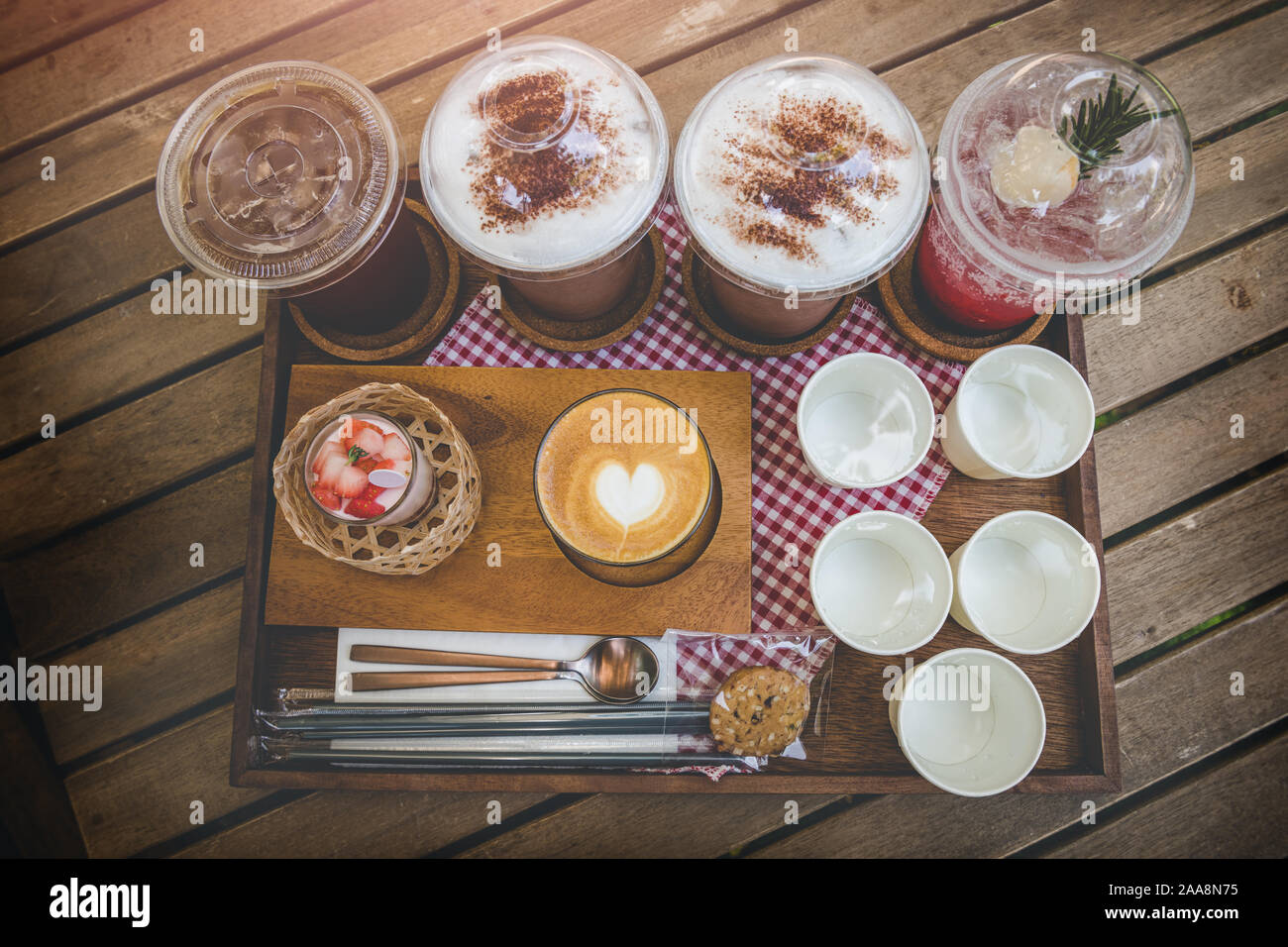 Coffeeshop drink mix set about cold and hot coffee cocoa and cup cake in wooden plate serve. Stock Photo