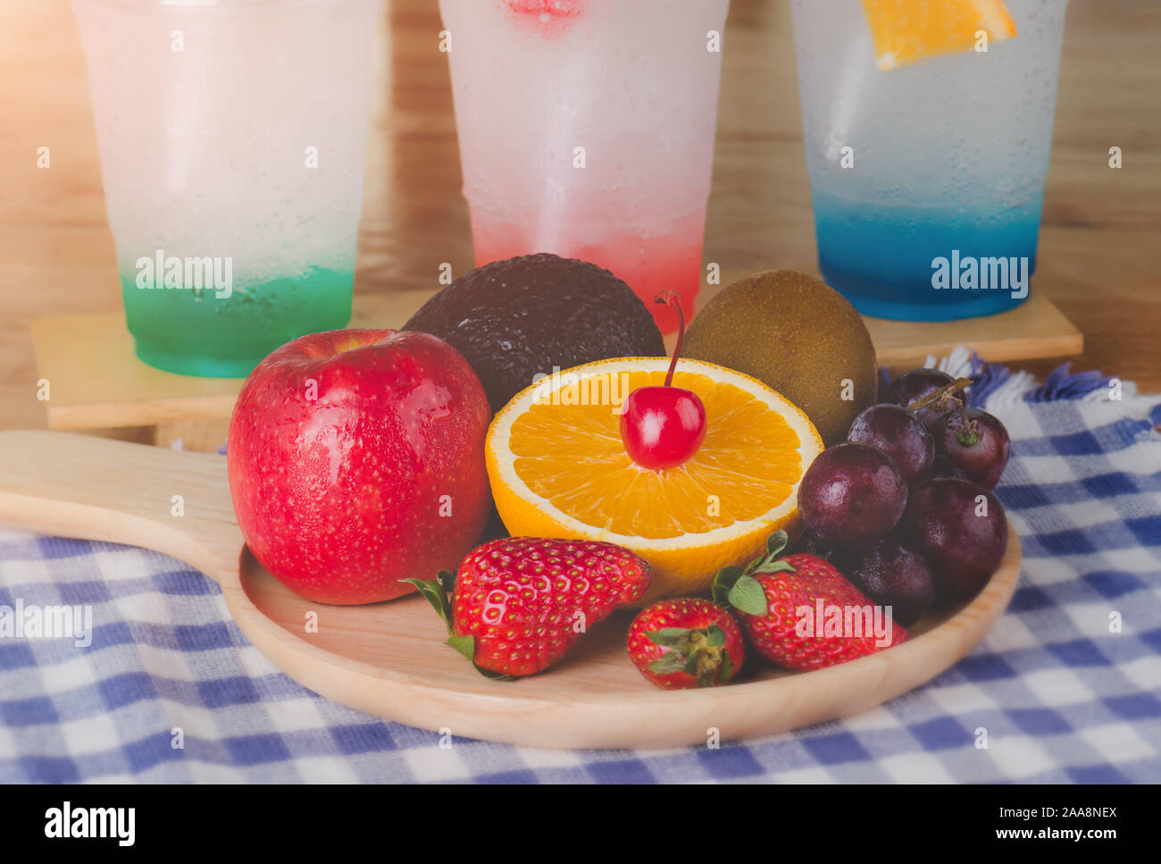 Mix fruits in wooden plate with window lighting.. Stock Photo