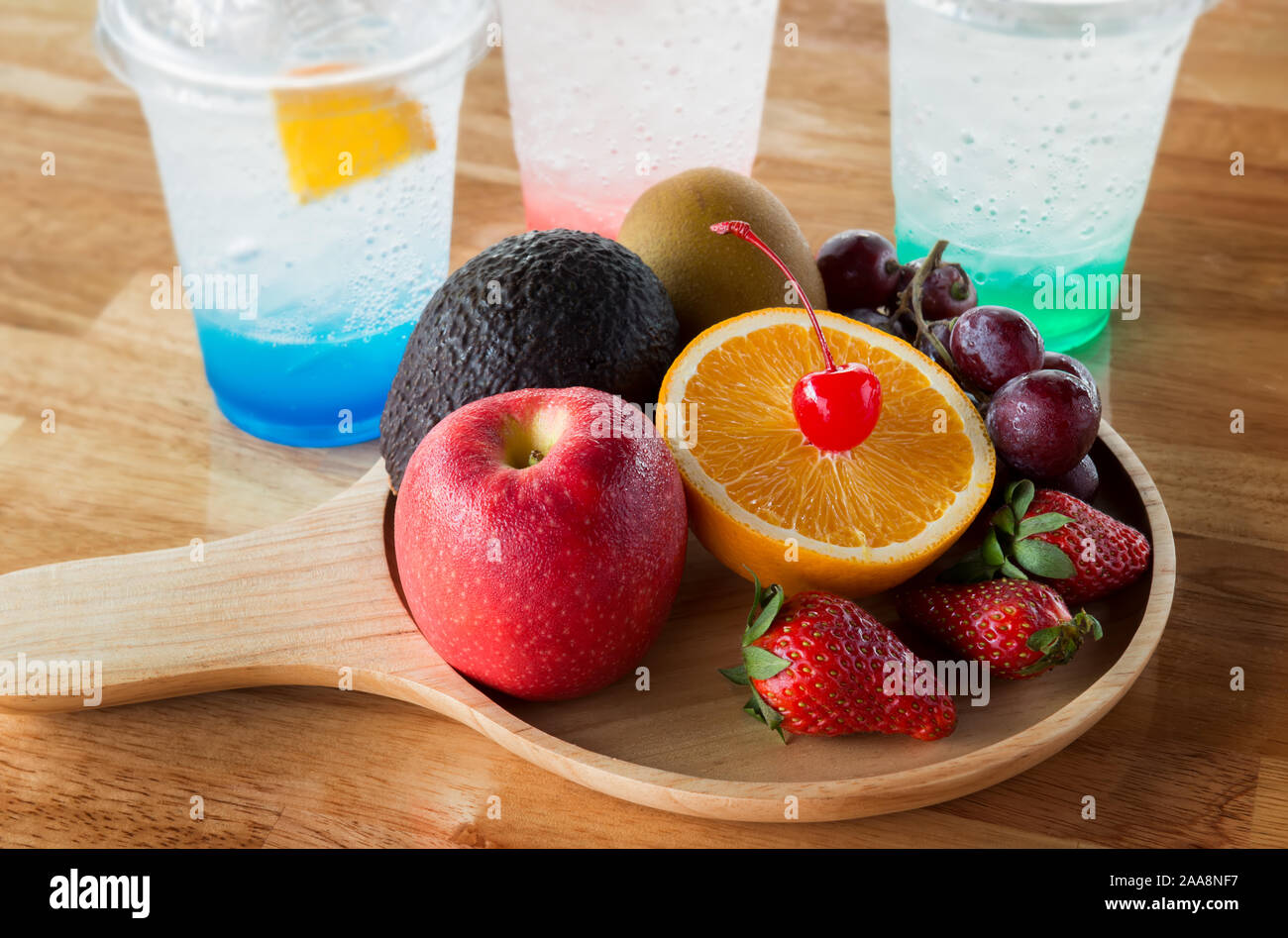 Mix fruits in wooden plate with window lighting.. Stock Photo