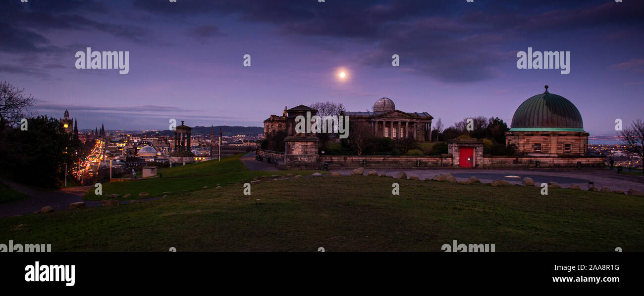 Edinburgh, Scotland, UK - January 11, 2012: The moon sets over Edinburgh's Calton Hill Observatory at dawn. Stock Photo