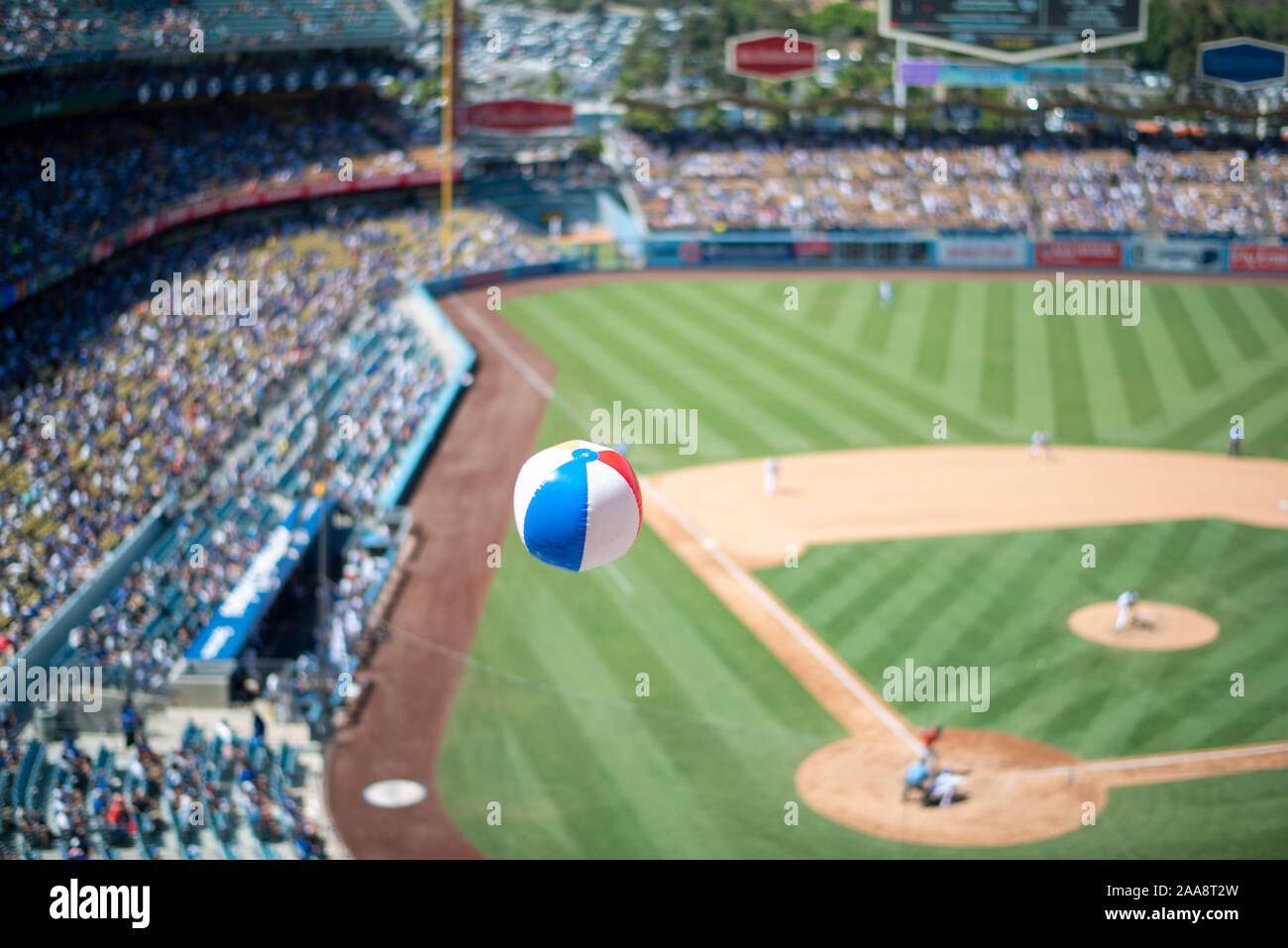 Beach ball floating above the field and stands of a baseball game Stock Photo