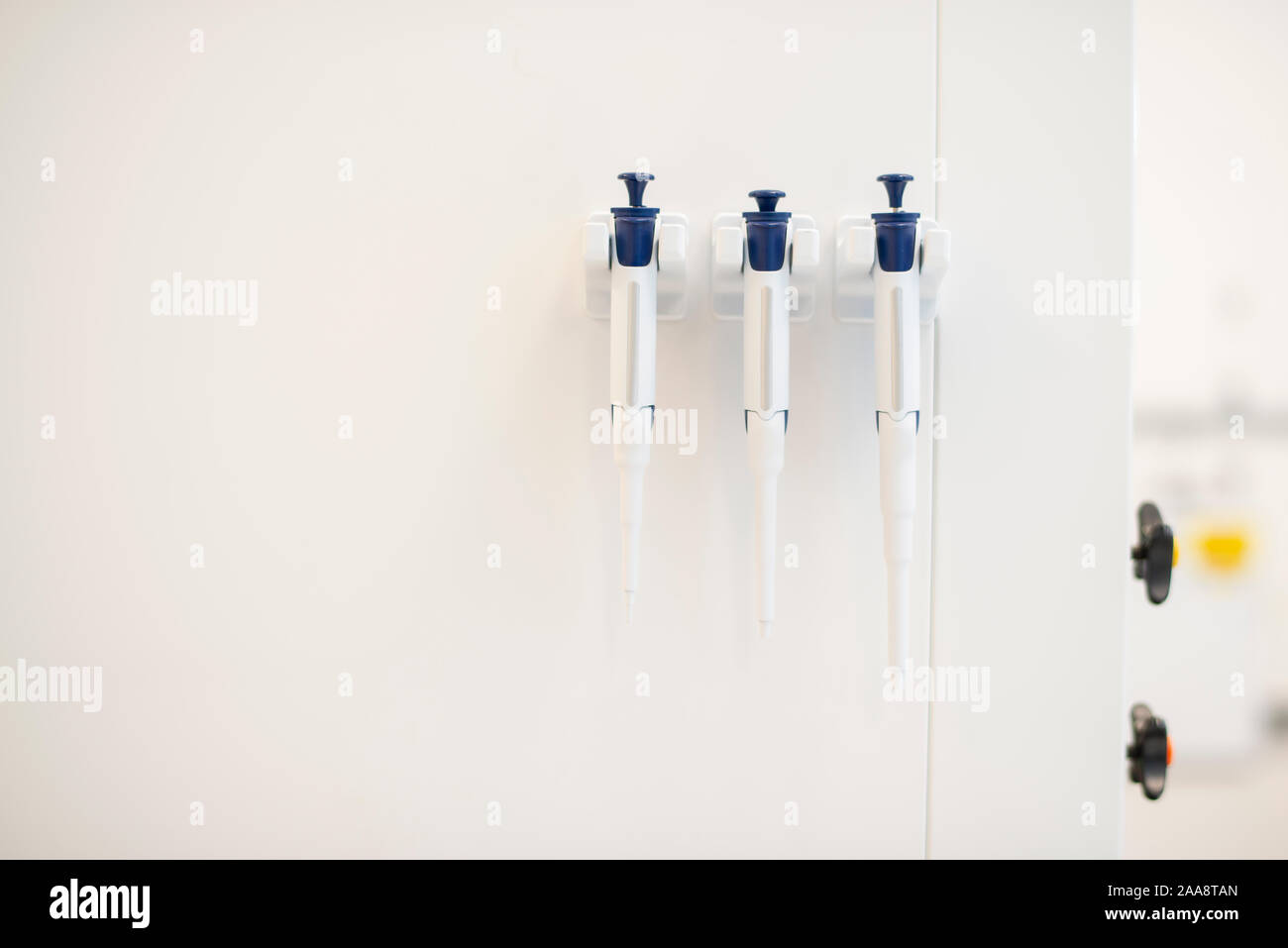 Three pipettes hanging in a laboratory Stock Photo