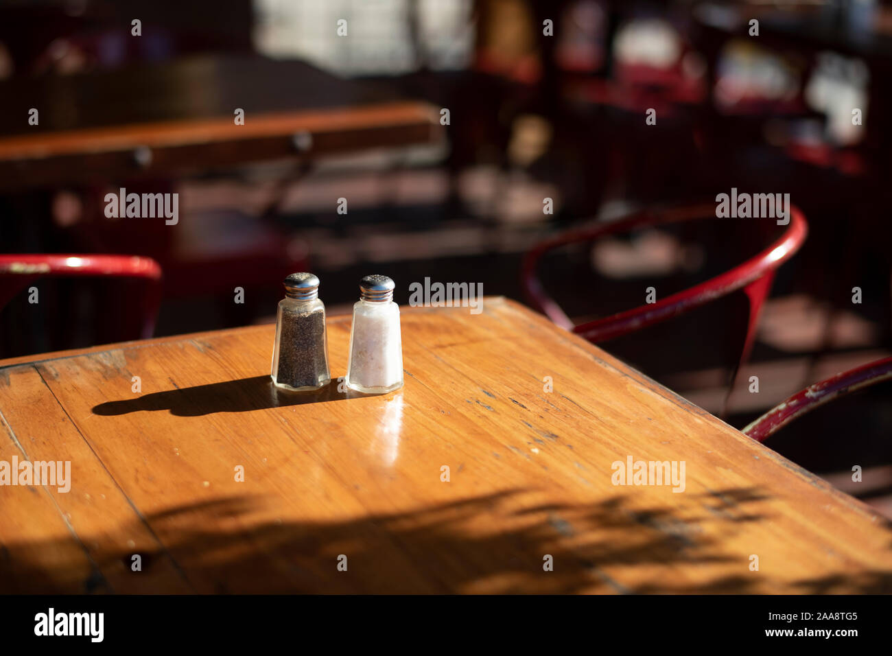 Table with salt and pepper shakers in an empty American diner Stock