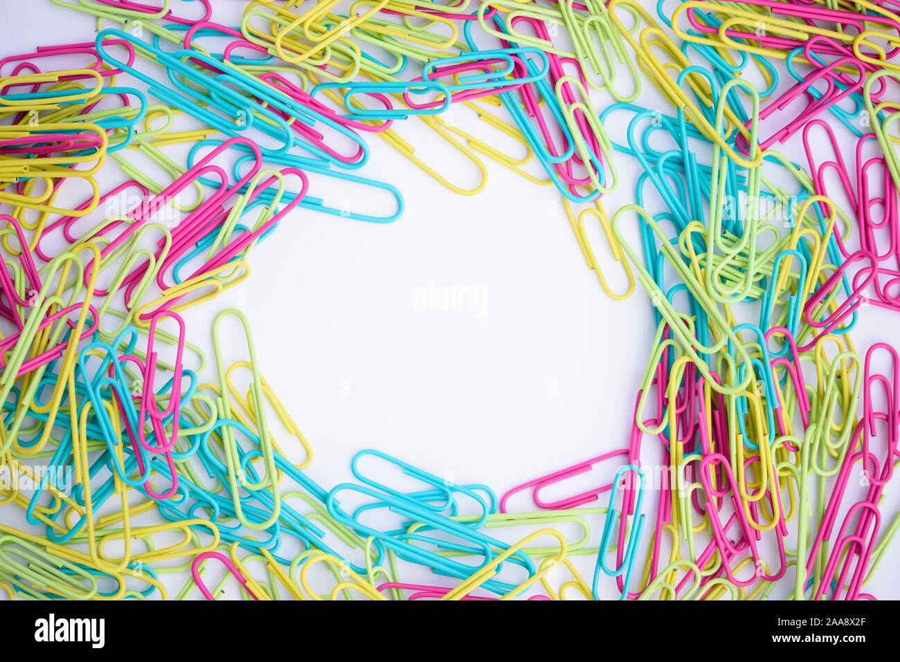 happy vibrant paper clip office supplies on white desk Stock Photo Alamy