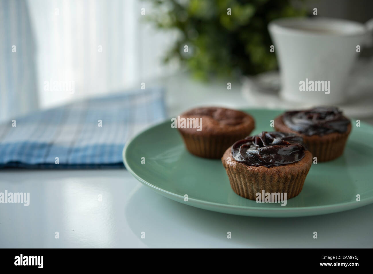 Three muffins with chocolate cream and fresh coffee Stock Photo