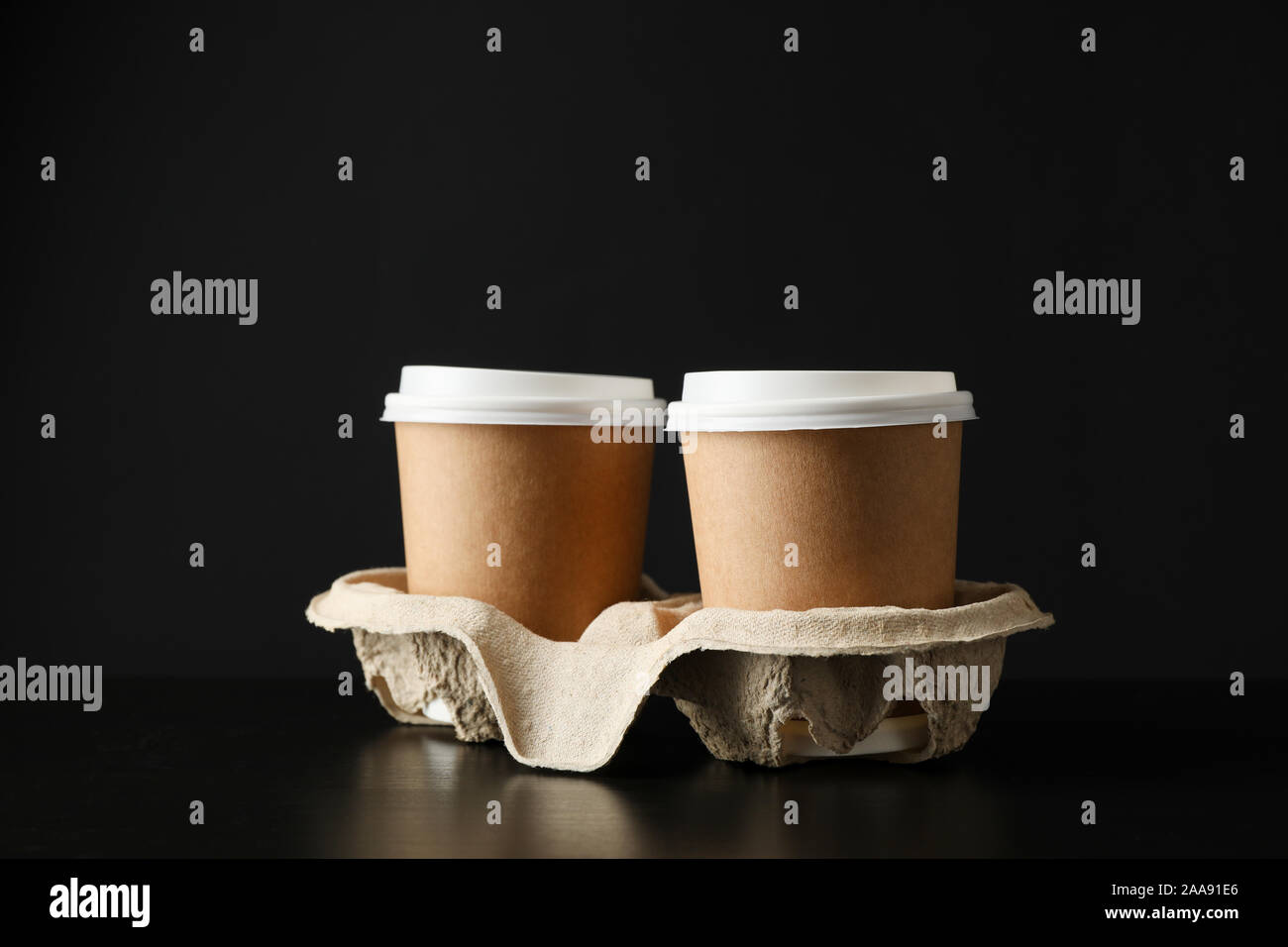 Eco - friendly coffee cups on black background, space for text Stock Photo