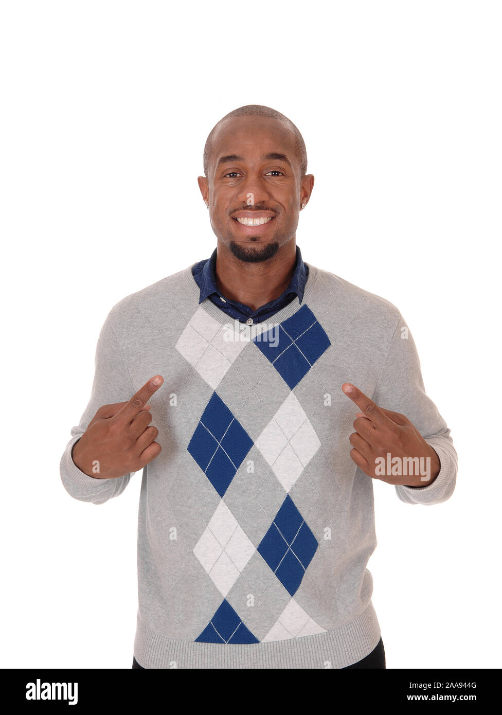 A handsome African American man standing in a sweater, smiling and pointing with his fingers at himself, isolated for white background Stock Photo