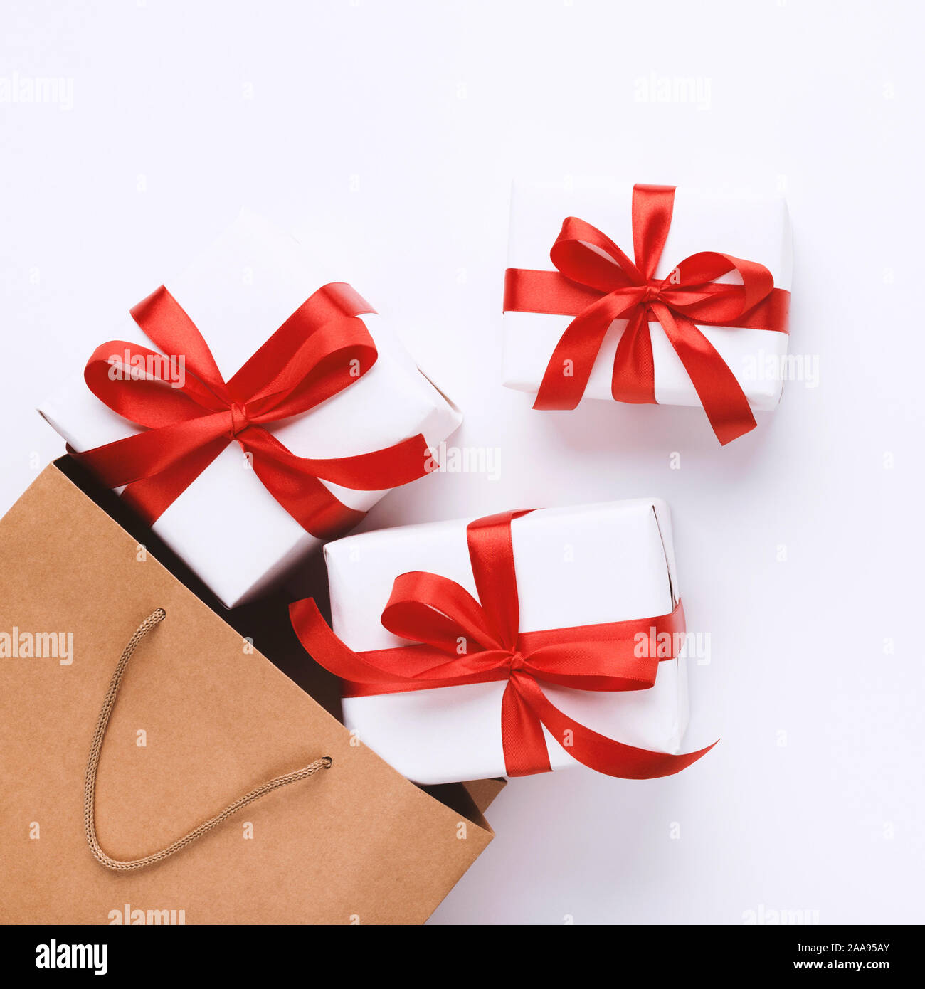Many Christmas gifts with red ribbons and shopping bag Stock Photo