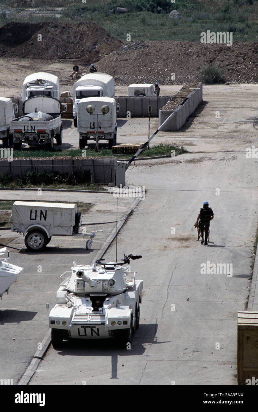 5th August 1993 During the Siege of Sarajevo: a Panhard ERC (Engin de Reconnaissance Cannon) 90 F4 Sagaie Armoured Car and several Renault TRM 2000 Light Utility trucks at the rear of the French UN base, next to the BHRT Building (television centre), in the west of the city. Stock Photo