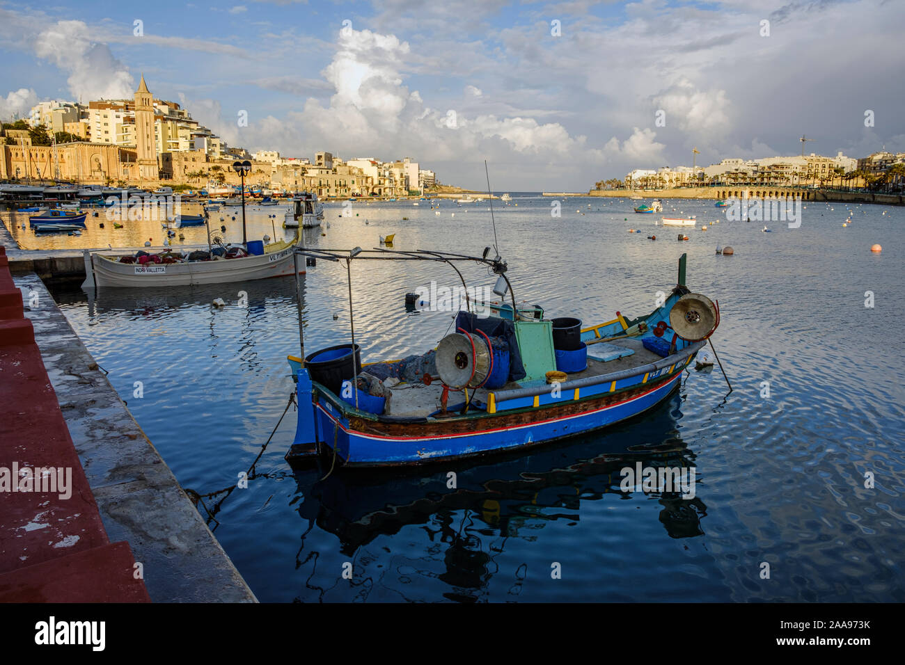 A luzzu, one of the traditional brightly coloured Maltese fishing boats in the harbour at Marsaskala, Malta Stock Photo