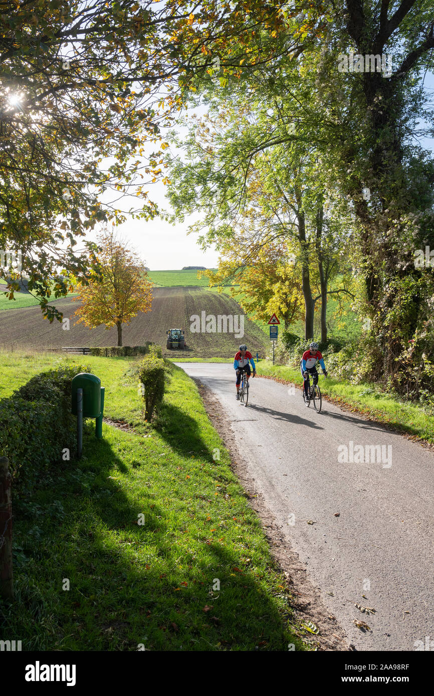 two men cycle in hill country of south limburg in the netherlands Stock Photo