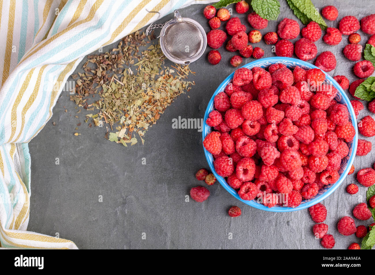 Tea Towel Raspberry Cup of raspberry with dry tea leaf and striped kithen towel Stock Photo ...