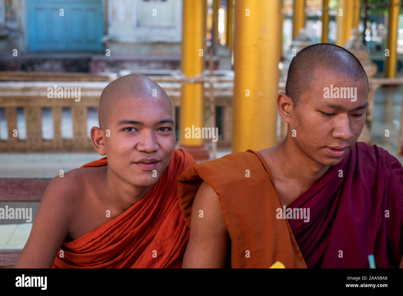 Two youthful Buddhist monks reciting prayers at a monastery in Myanmar (Burma) during a Buddhist holy day Stock Photo