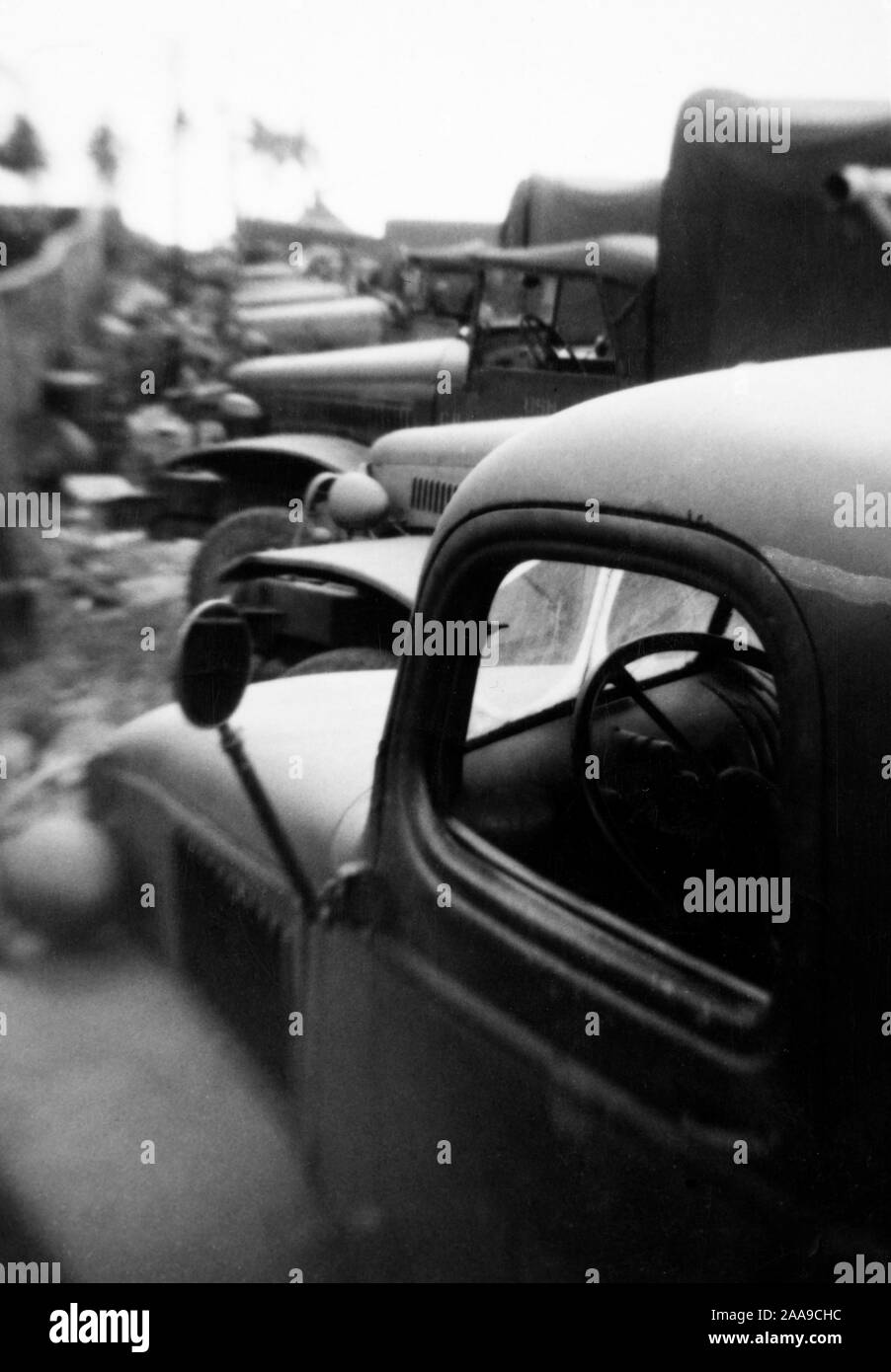 Supply vehicles are lined up at a Navy base in Guam, ca. 1944. Stock Photo