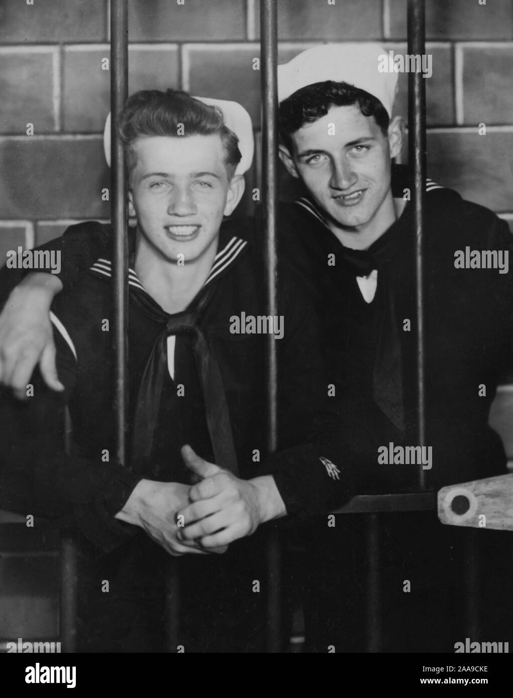 Two US Navy sailors pose in the pretend brig, ca. 1944. Stock Photo