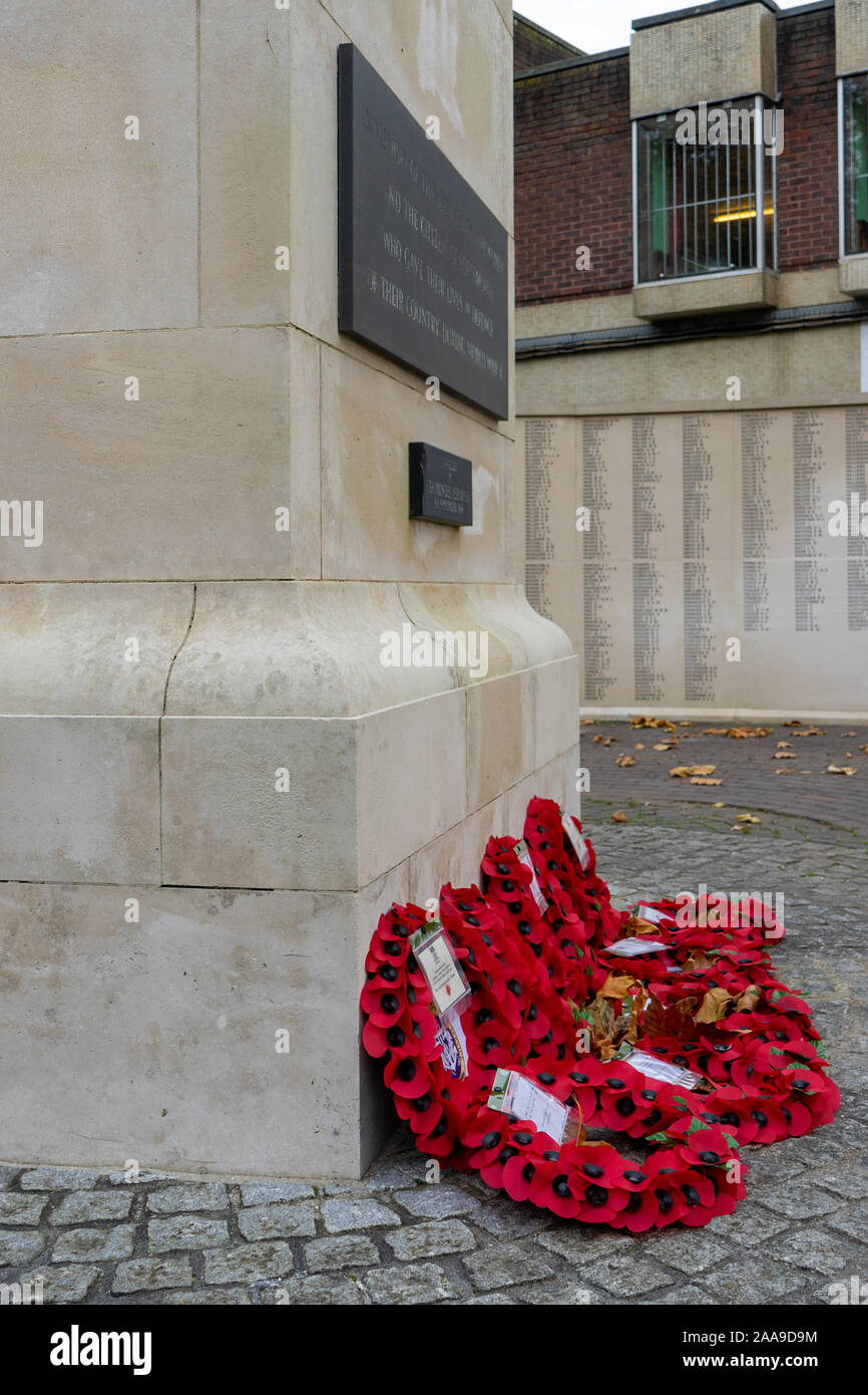 Red poppy wreathes laid around a War memorial on Remembrance Sunday Stock Photo