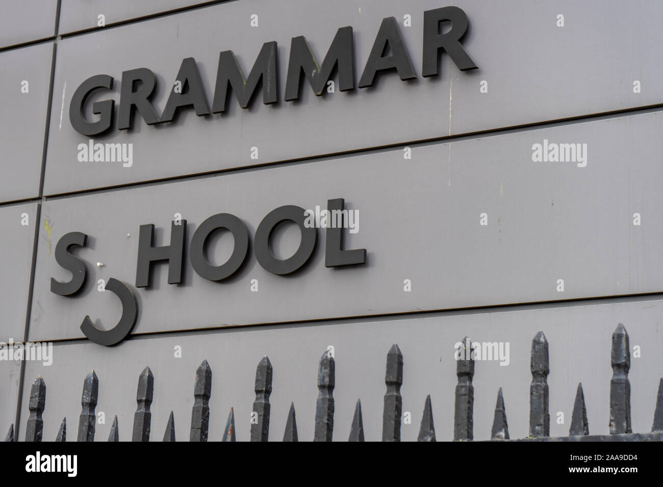 A broken Grammar school sign with the C dangling down Stock Photo