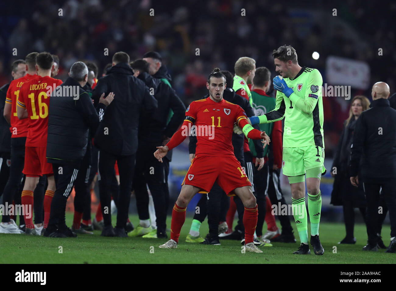Gareth Bale of Wales (11) shows off some dance moves to Wales goalkeeper Wayne Hennessey as they celebrate their qualification.UEFA Euro 2020 qualifier group E match, Wales v Hungary at the Cardiff city Stadium in Cardiff , South Wales on Tuesday 19th November 2019. pic by Andrew Orchard/Andrew Orchard sports photography/Alamy live News EDITORIAL USE ONLY Stock Photo
