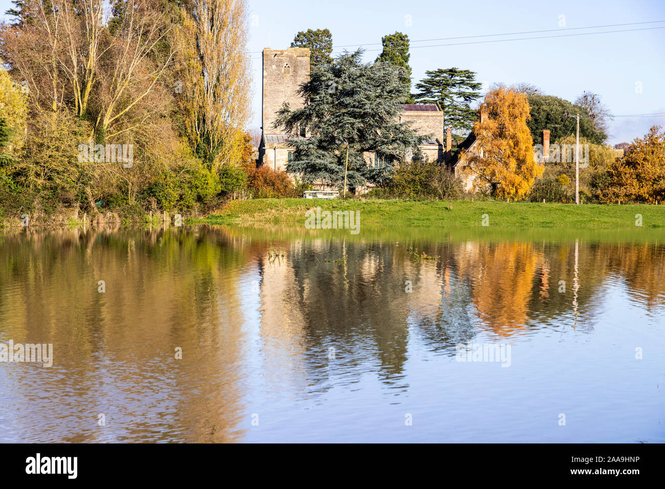 St Marys church seen across floodwater from the River Severn filling fields in the Severn Vale village of Deerhurst, Gloucestershire UK on 18/11/2019 Stock Photo