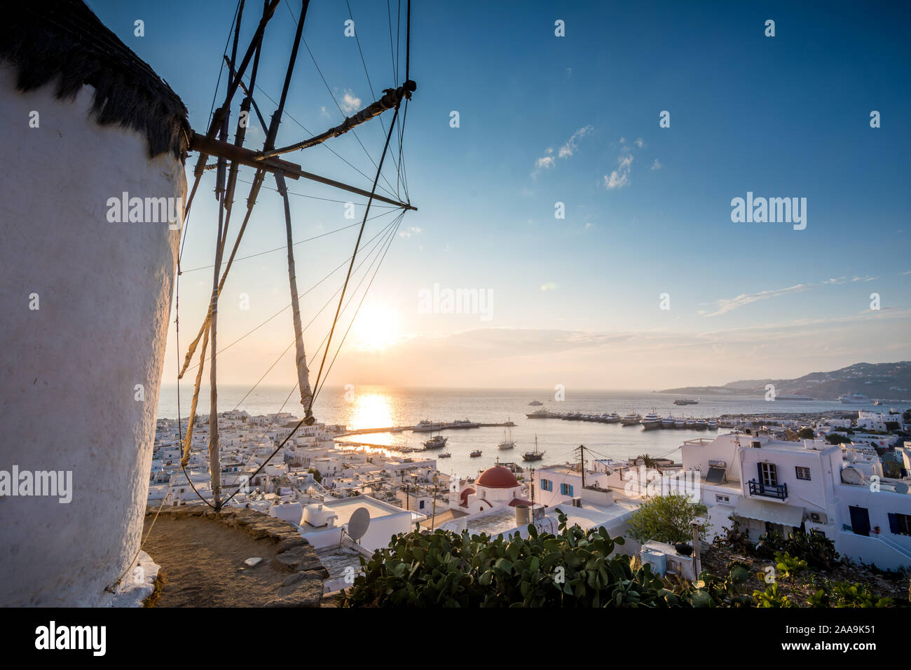 Sunset at Mykonos chora with part of a windmill in view Stock Photo