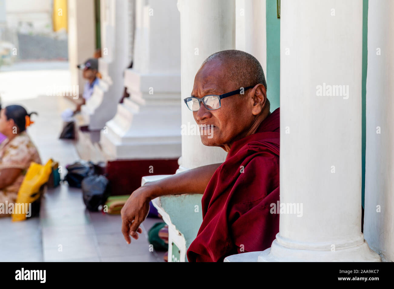 A Buddhist Monk At The Shwedagon Pagoda, Yangon, Myanmar. Stock Photo