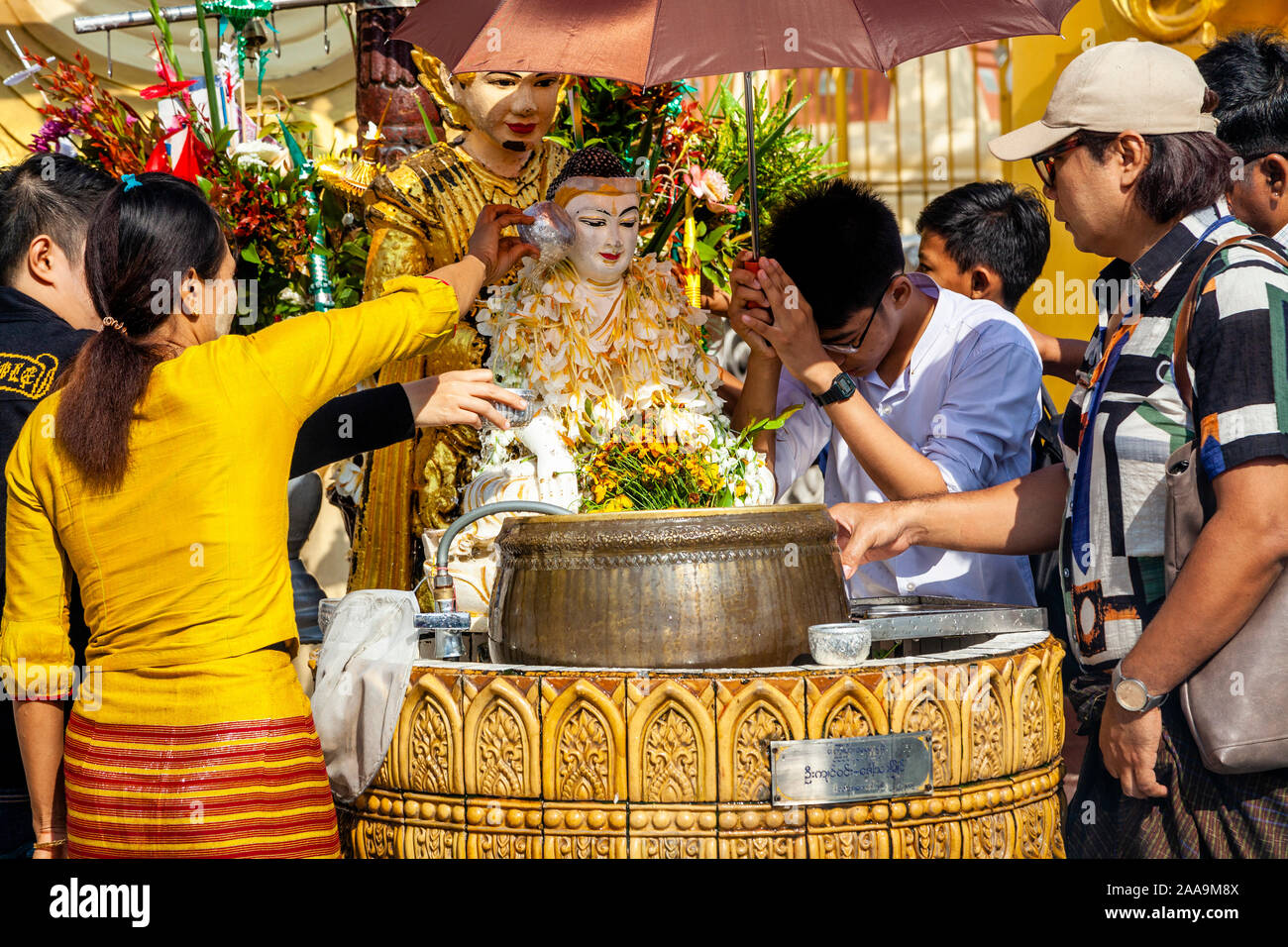 Buddhist People Take Part In The Ritual Of Pouring Water Over Buddhist