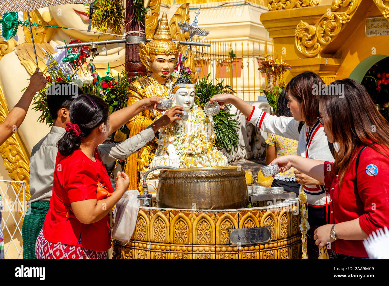 Buddhist People Take Part In The Ritual Of Pouring Water Over Buddhist