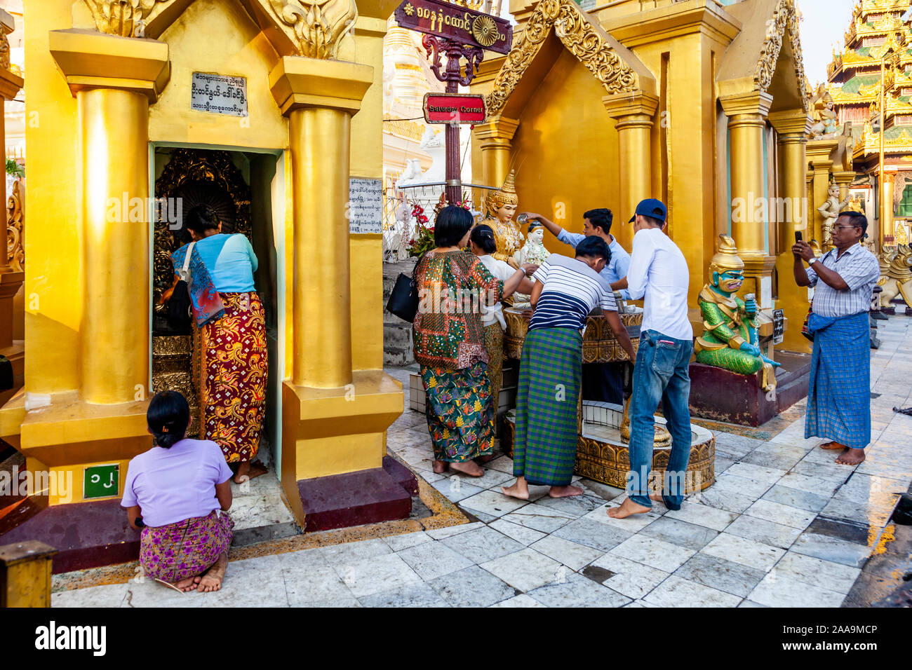 Buddhist People Take Part In The Ritual Of Pouring Water Over Buddhist