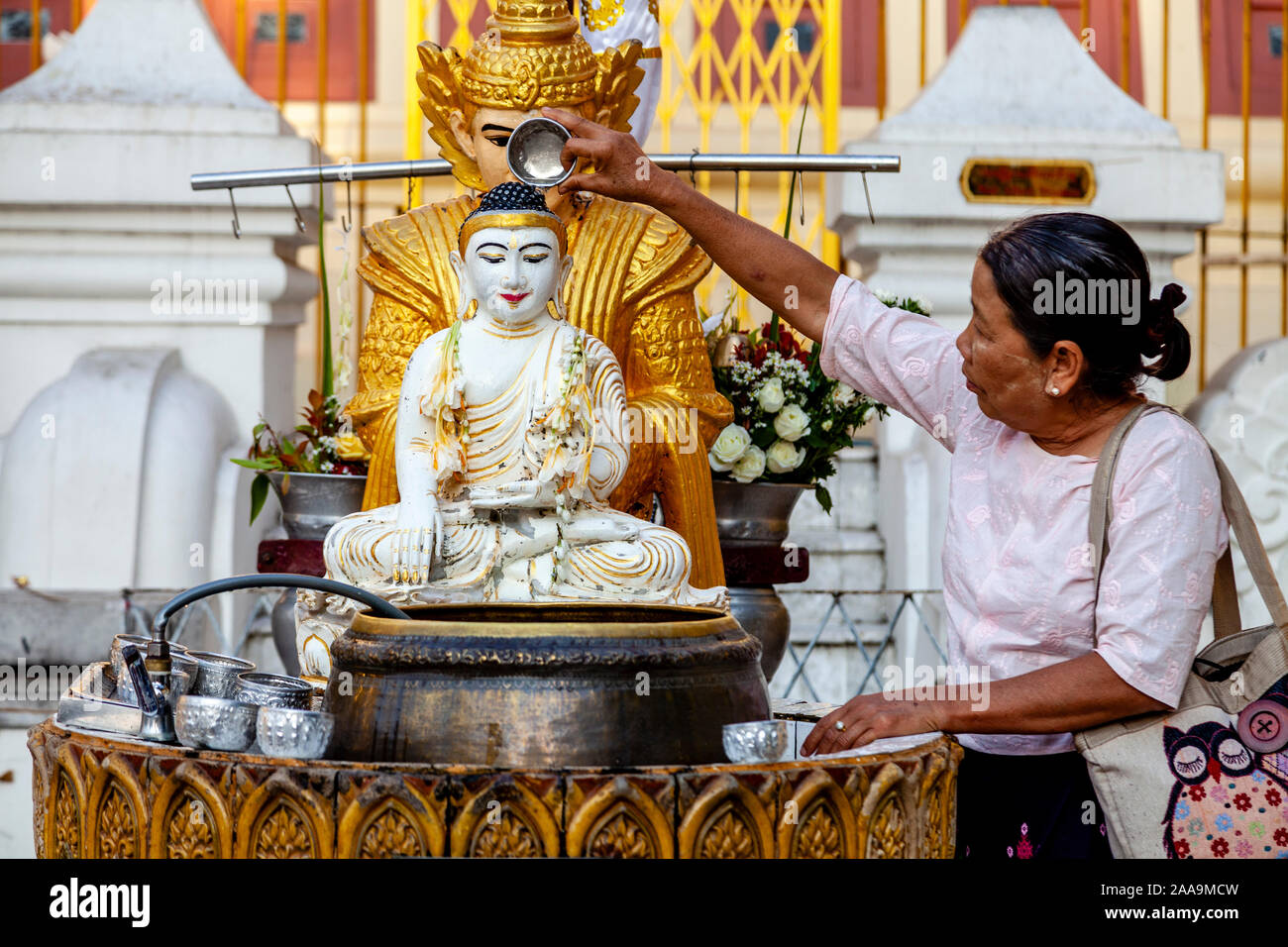 Buddhist People Take Part In The Ritual Of Pouring Water Over Buddhist