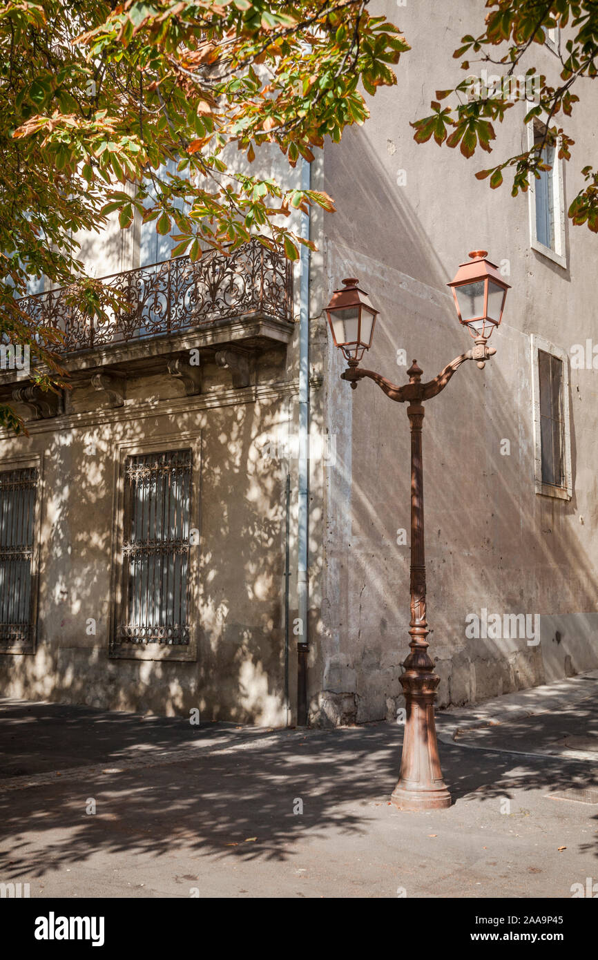 Street corner with horsechestnut trees in autumnal colours in Beziers
