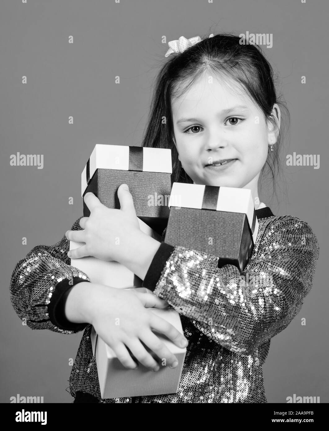 Child carry lot gift boxes. Kids fashion. Surprise gift box. Birthday wish list. Special happens every day. Shop for what you want. Girl with gift boxes blue background. Black friday. Shopping day. Stock Photo