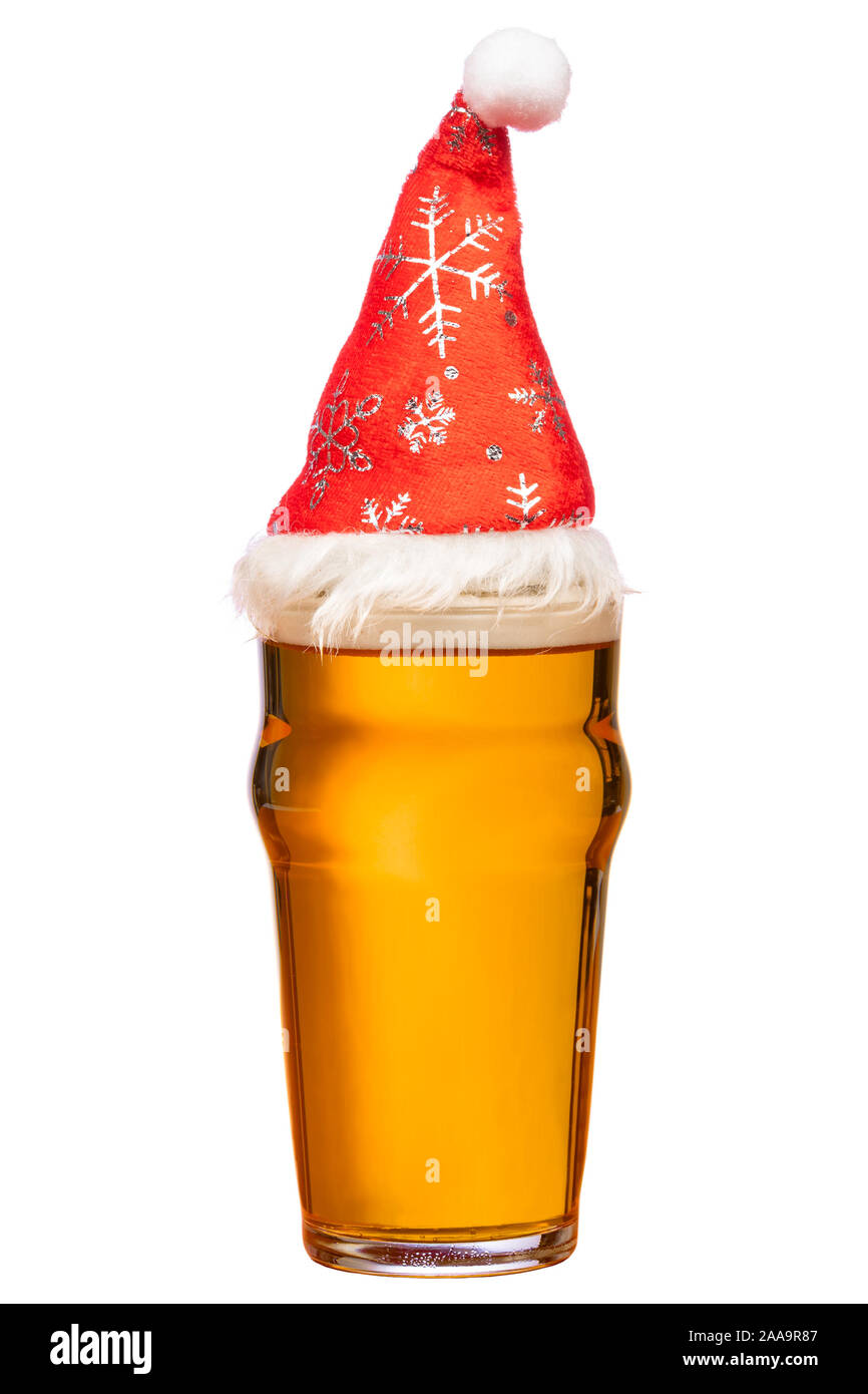 Full pint glass of lager beer or ale with Santa Claus red hat isolated on white background Stock Photo