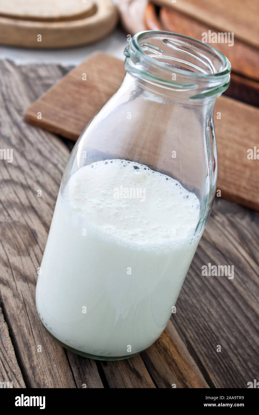 Bottle of milk and wooden background Stock Photo - Alamy